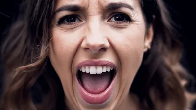 Young Woman Screaming Directly Into The Camera Lens