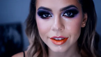 Young Woman Applying Glitter Makeup To Her Face