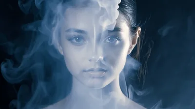 Young Woman With Blue Eyes Surrounded By Moving Smoke