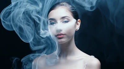 Young Woman Surrounded By Swirling White Smoke