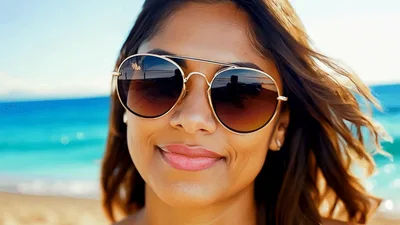Smiling Woman Wearing Sunglasses On A Sunny Beach