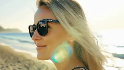 Blonde Woman Wearing Sunglasses Smiling On Sunny Beach