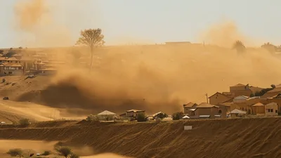 Sandstorm Engulfing Residential Neighborhood In Desert Landscape