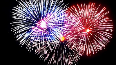 Colorful Fireworks Exploding Against A Dark Night Sky