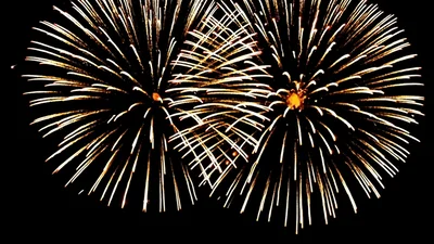 Bright Red And Gold Fireworks Exploding In Night Sky