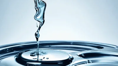 Water Droplet Falling Into A Metallic Surface