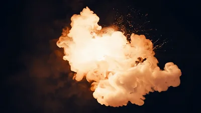 Large Fiery Explosion Expanding Against Dark Background
