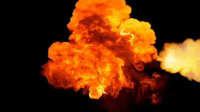 Large Fiery Explosion Transitioning Into Thick Purple Smoke