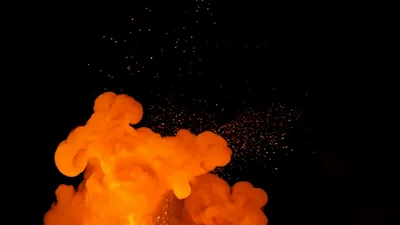Large Fiery Explosion With Glowing Sparks Against Black Background