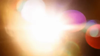 Bright Golden Lens Flare With Colorful Bokeh Effects
