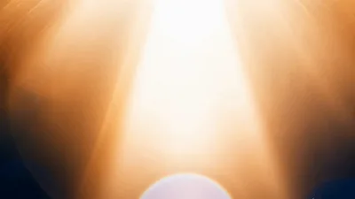 Golden Light Rays Shining Downward With Lens Flare