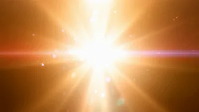 Golden Light Burst With Floating Particles Background
