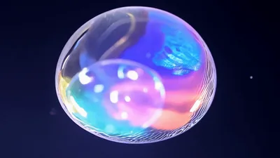 Iridescent Soap Bubble Floating Against Dark Background
