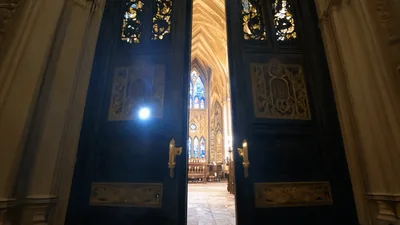 Ornate Church Doors Opening to Reveal Gothic Interior
