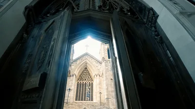 Large Ornate Church Doors Opening To Reveal Cathedral Facade