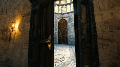 Heavy Wooden Door Opening Into A Grand Stone Hall