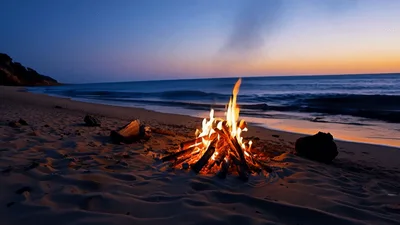 Bonfire Burning On A Sandy Beach At Sunset