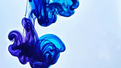 Blue Ink Droplets Dissolving In Clear Water