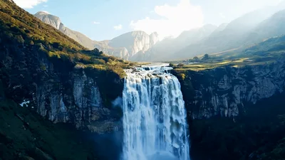 Aerial View Of Majestic Waterfall With Rainbow