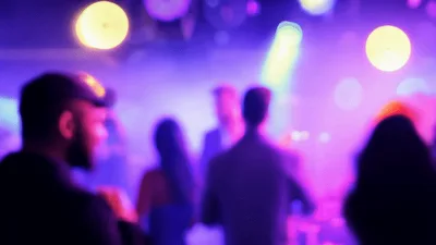 Crowd Dancing at a Nightclub with Colorful Stage Lighting