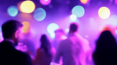 Crowd Dancing At A Nightclub With Colorful Bokeh Lights