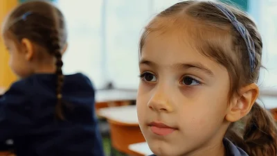 Young Girl Smiling During Classroom Lesson