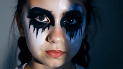 Young Girl With Dramatic Halloween Bat Eye Makeup