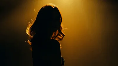 Silhouette Of A Woman Turning To Face The Camera