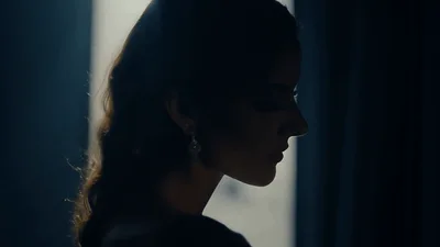 Elegant Woman Opening Curtains In A Dark Room