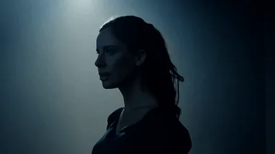 Woman Emerging From Shadows Into Spotlight