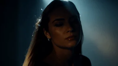 Woman Turning Her Head In Dark Moody Lighting
