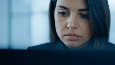 Professional Woman Working On Laptop In Modern Office