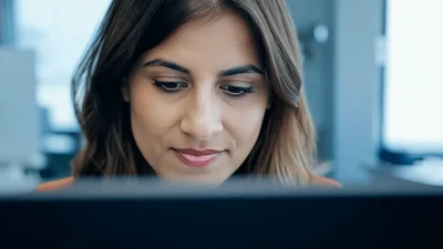 Professional Woman Working On Laptop In Modern Office