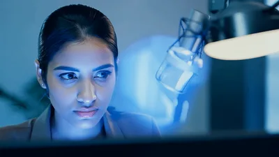Professional Woman Working Late At Night On Laptop