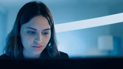 Young Professional Woman Working On Laptop In Modern Office