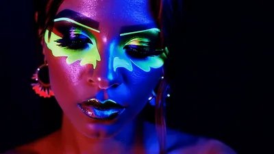 Woman With Neon Fluorescent Makeup Looking At Camera