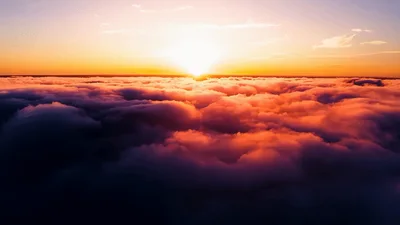 Aerial View Of Golden Sunset Above Thick Clouds