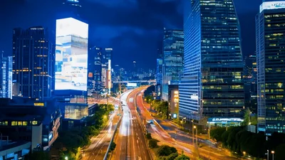 Nighttime Timelapse Of Busy Urban Highway Traffic