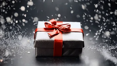 Silver Gift Box With Red Ribbon Under Falling Snow