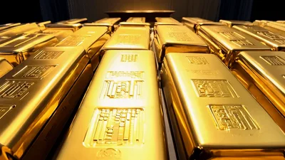 Shiny Gold Bars Arranged in Rows on Dark Surface
