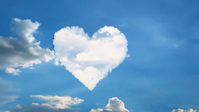 Heart Shaped Cloud Floating In Blue Sky