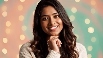 Smiling Young Woman Posing Against Bokeh Background