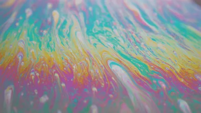 Macro View Of Swirling Iridescent Soap Bubble Film