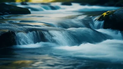 Crystal Clear Water Flowing Over River Rocks
