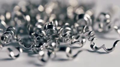 Macro Shot Of Shiny Metal Shavings On White Surface