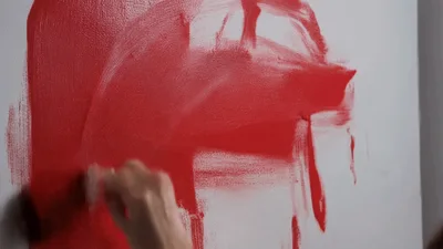 Woman Painting Red Paint On White Wall