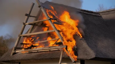 Thatched Roof House Burning With Intense Flames