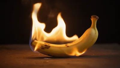 Banana Burning With Bright Orange Flames On Dark Surface