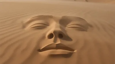 Surreal Human Face Sculpted Into Desert Sand Dunes