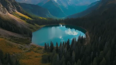 Aerial View Of Blue Alpine Lake In Mountain Valley